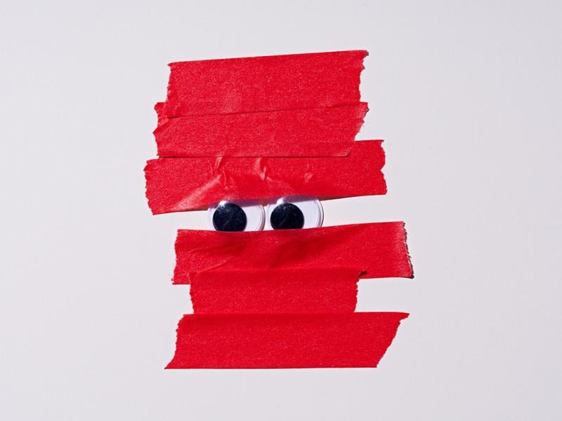 Googly eyes covered by red tape