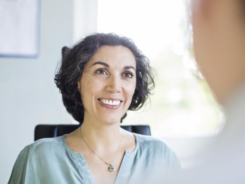 Person smiles at another individual