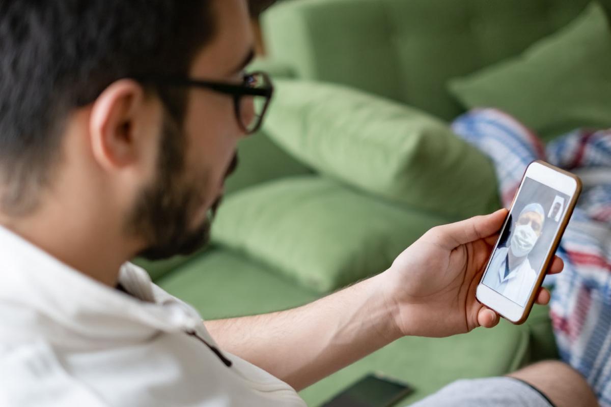 Man consulting with doctor via smartphone