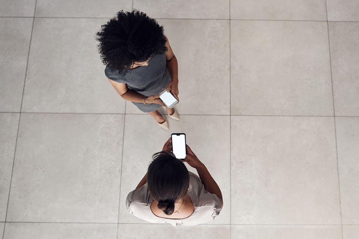 Overhead shot of two people using smartphones