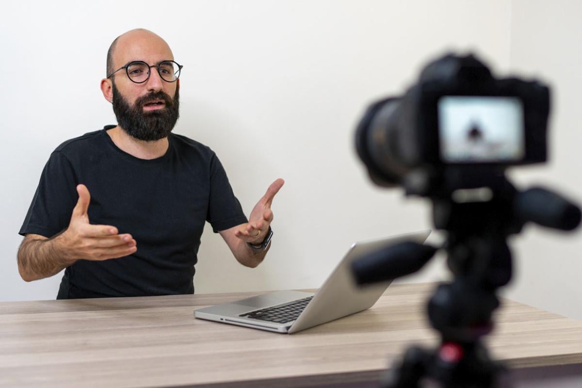 Man speaking in front of a digital camera