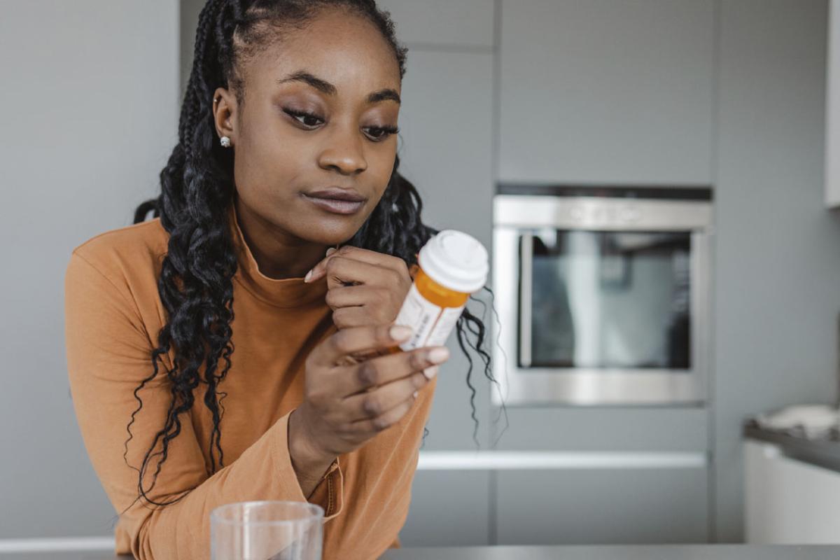 Woman looking at prescription medication