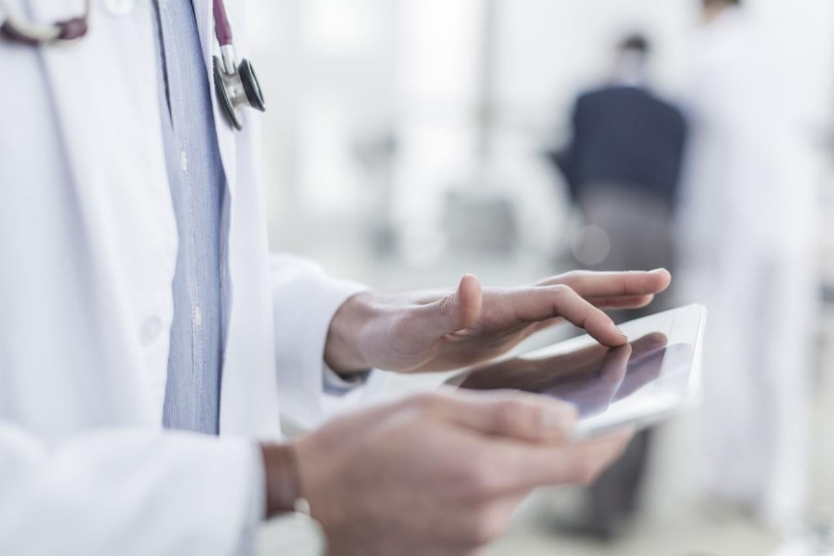 Doctor using a digital tablet