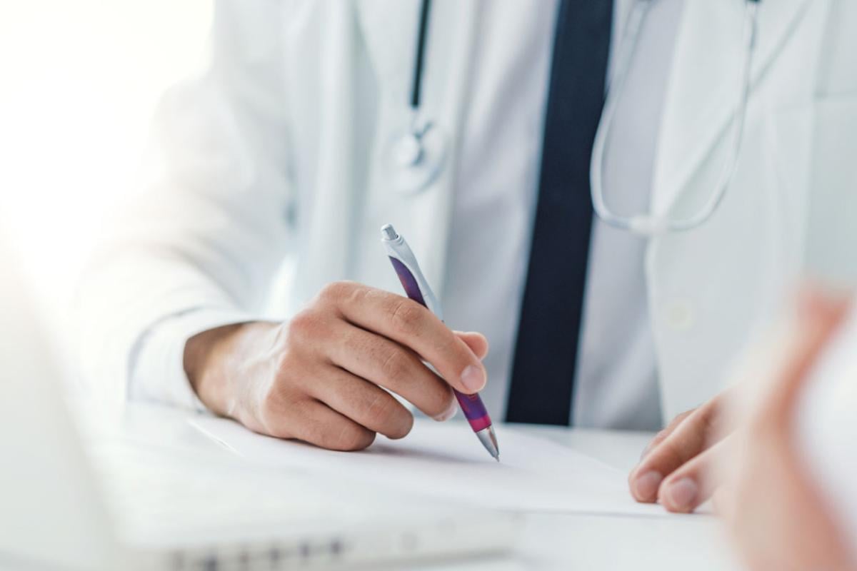 Physician holding a pen