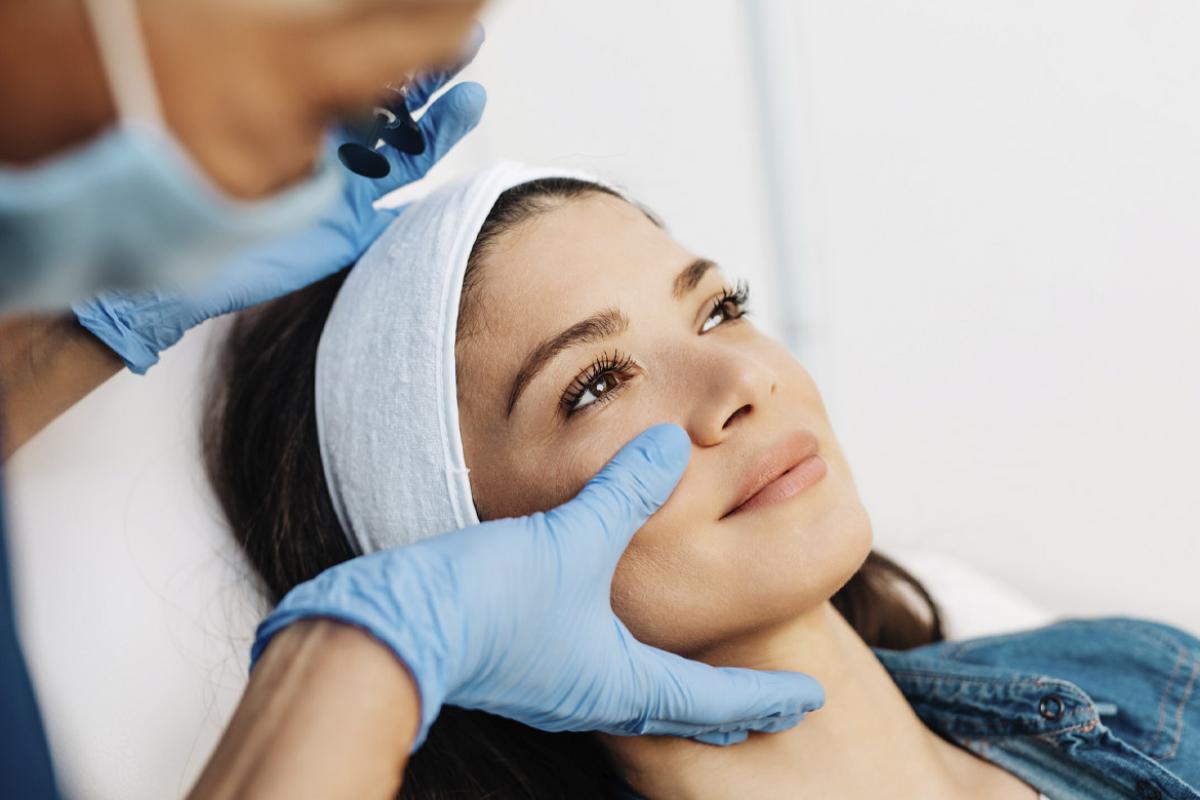 Person receiving facial aesthetics treatment